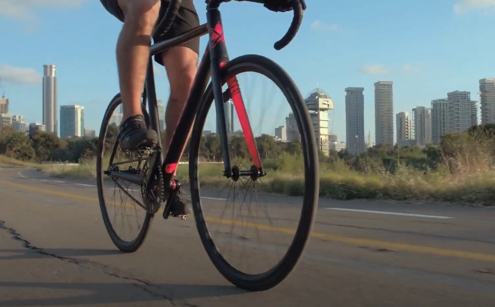 Photo showing guy's legs while riding a bike on the road