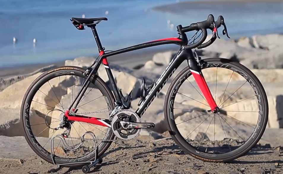 Black and red Tamac Sl4 bike standing by the sea