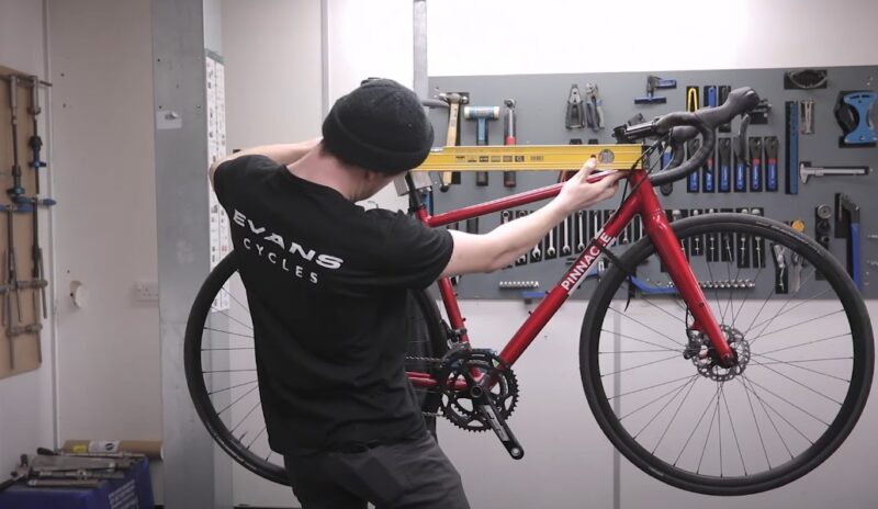 Guy measures bikes top bar length