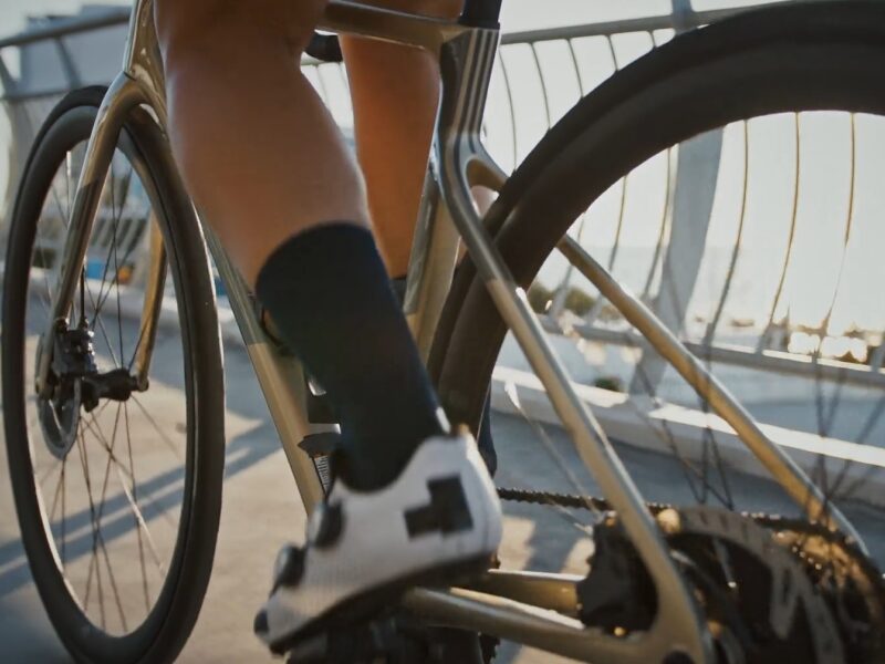 A close up on a cyclist's leg while pedaling