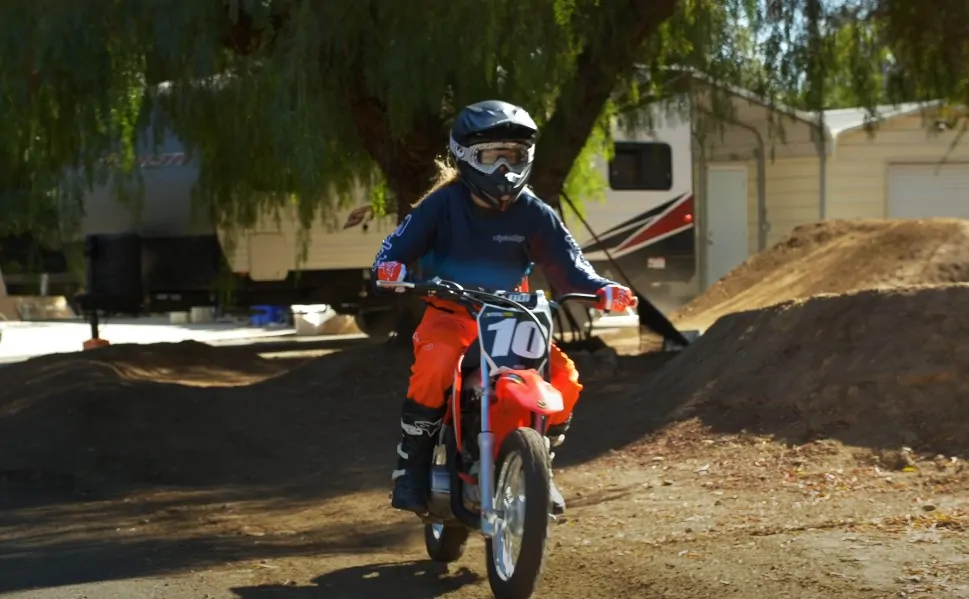 A man on a 110cc dirt bike