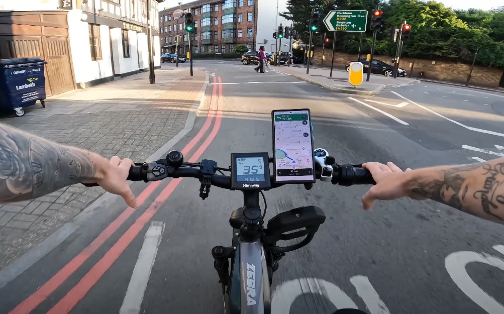 Guy rides e-bike through the city with camera on his helmet