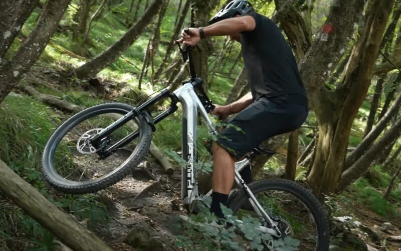 Guy drives eMTB in the forest