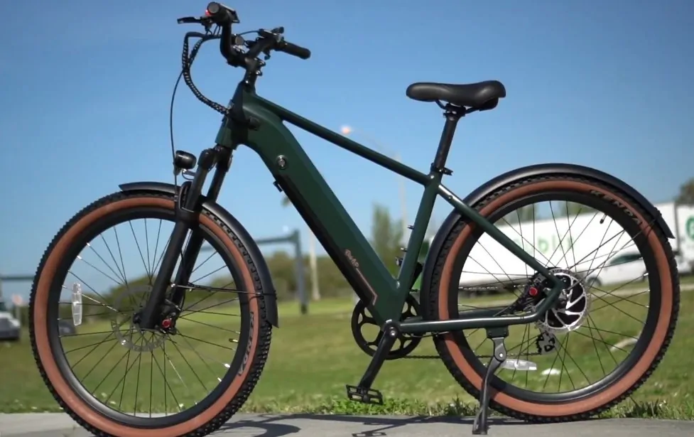 Green bicycle stands on a parking bracket