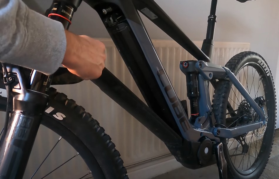 A guy is removing battery from his e-bike