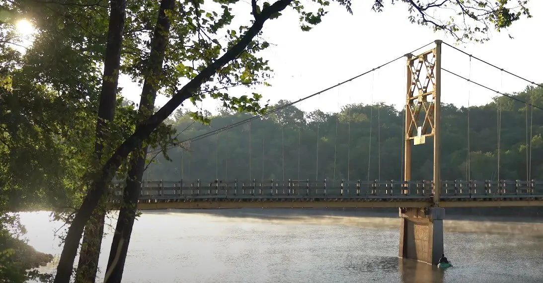 Early morning light illuminates the Pig Trail bridge over the river