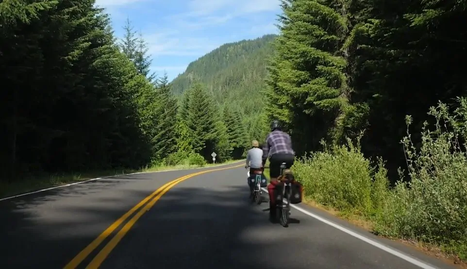 Cyclists navigate a scenic mountain road