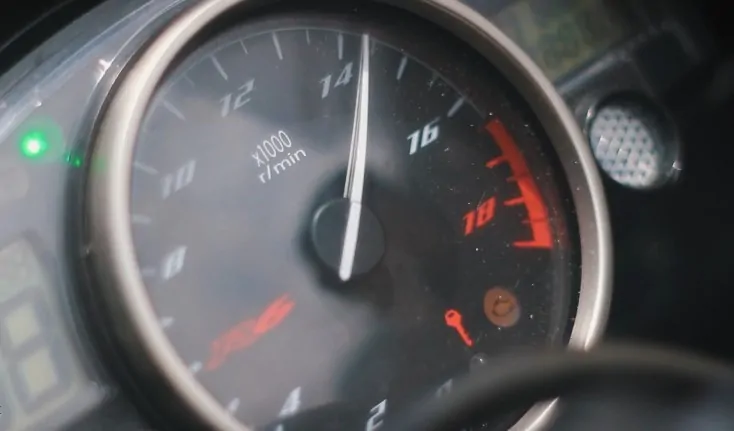 Close-up of a motorcycle's tachometer, showing a specific RPM reading
