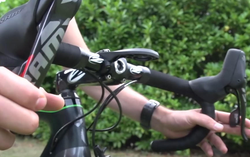 Close-up of a cyclist's hands gripping the handlebars of a road bike