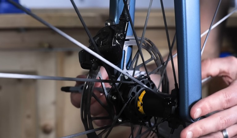 Close-up of a bicycle's disc brake caliper and rotor assembly