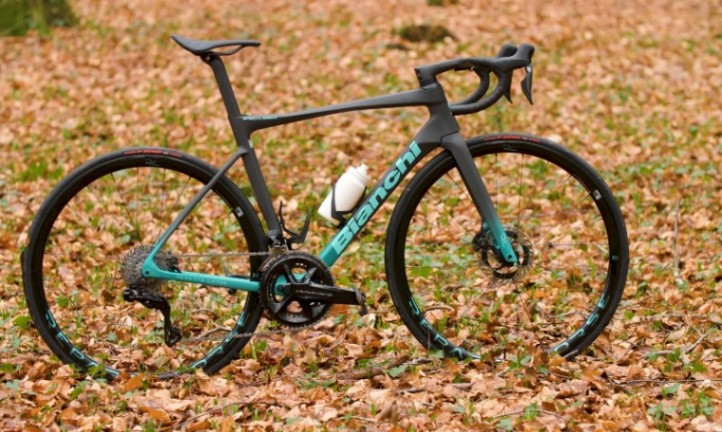 Sleek, dark Bianchi road bike with striking teal accents