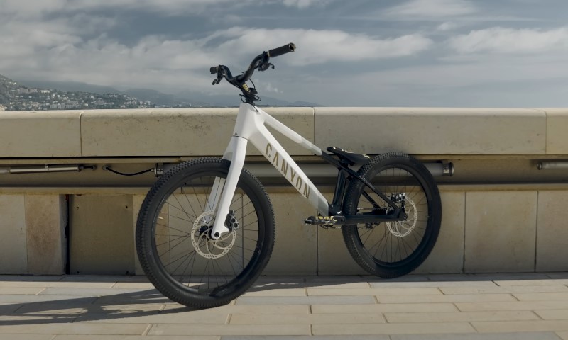White Canyon bike resting on a paved promenade