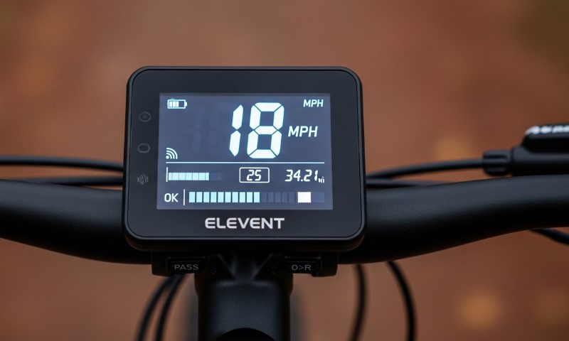 Digital bike display showing speed at 18 MPH, battery and ride distance of 34.2 miles