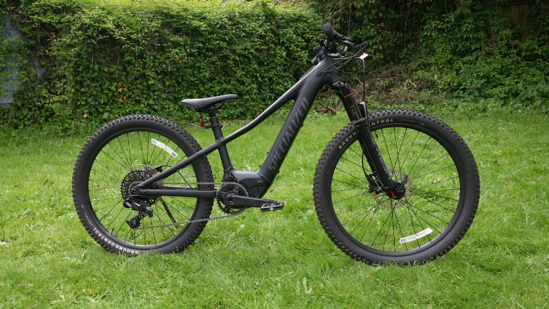 Specialized Turbo Levo SL Kids electric mountain bike with 24-inch wheels and mid-drive motor on grass